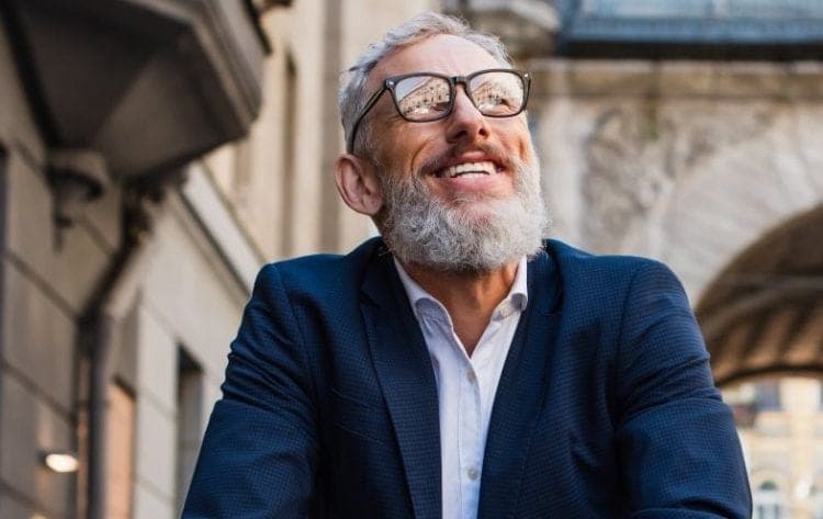 A business owner smiling, having planned a successful exit