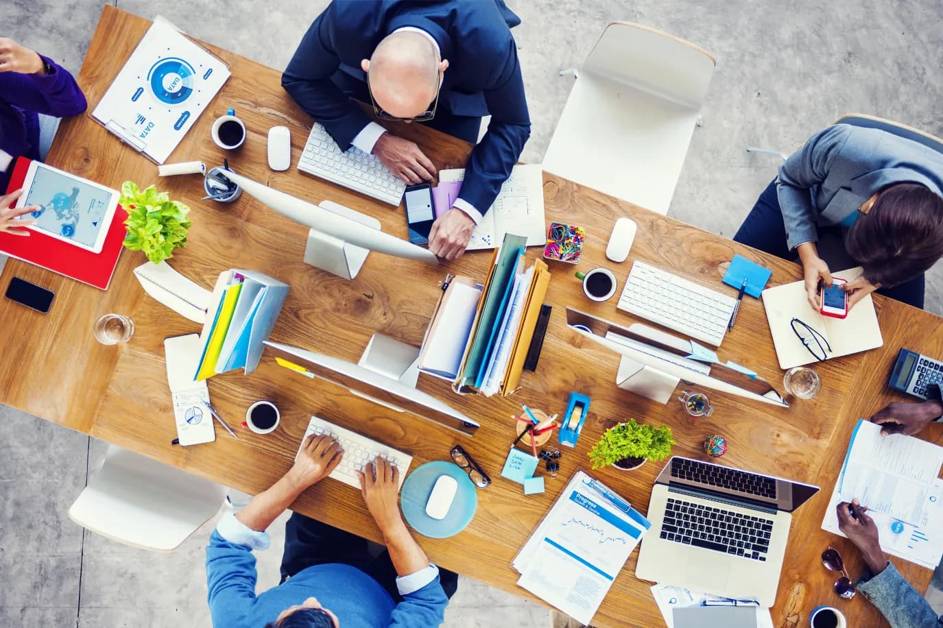 Overhead view of a business team analysing financial data and reports