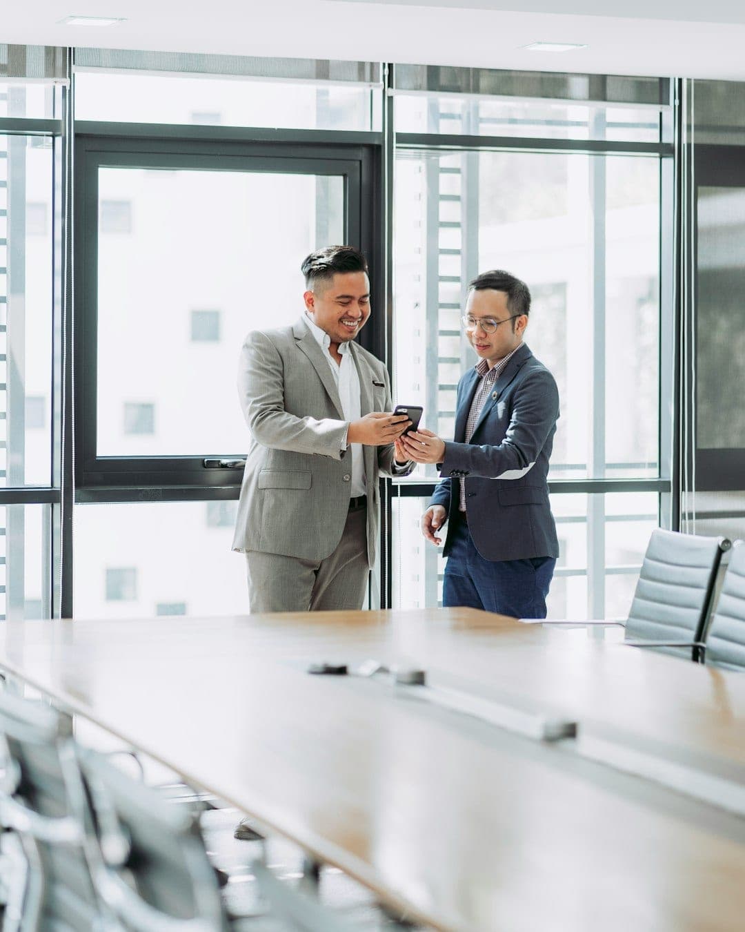 Two business professionals discussing a business valuation in a modern boardroom