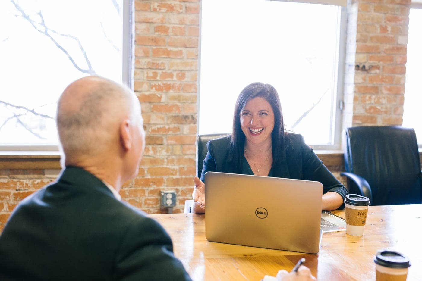 A recruitment business owner in a confidential advisory conversation with a specialist adviser
