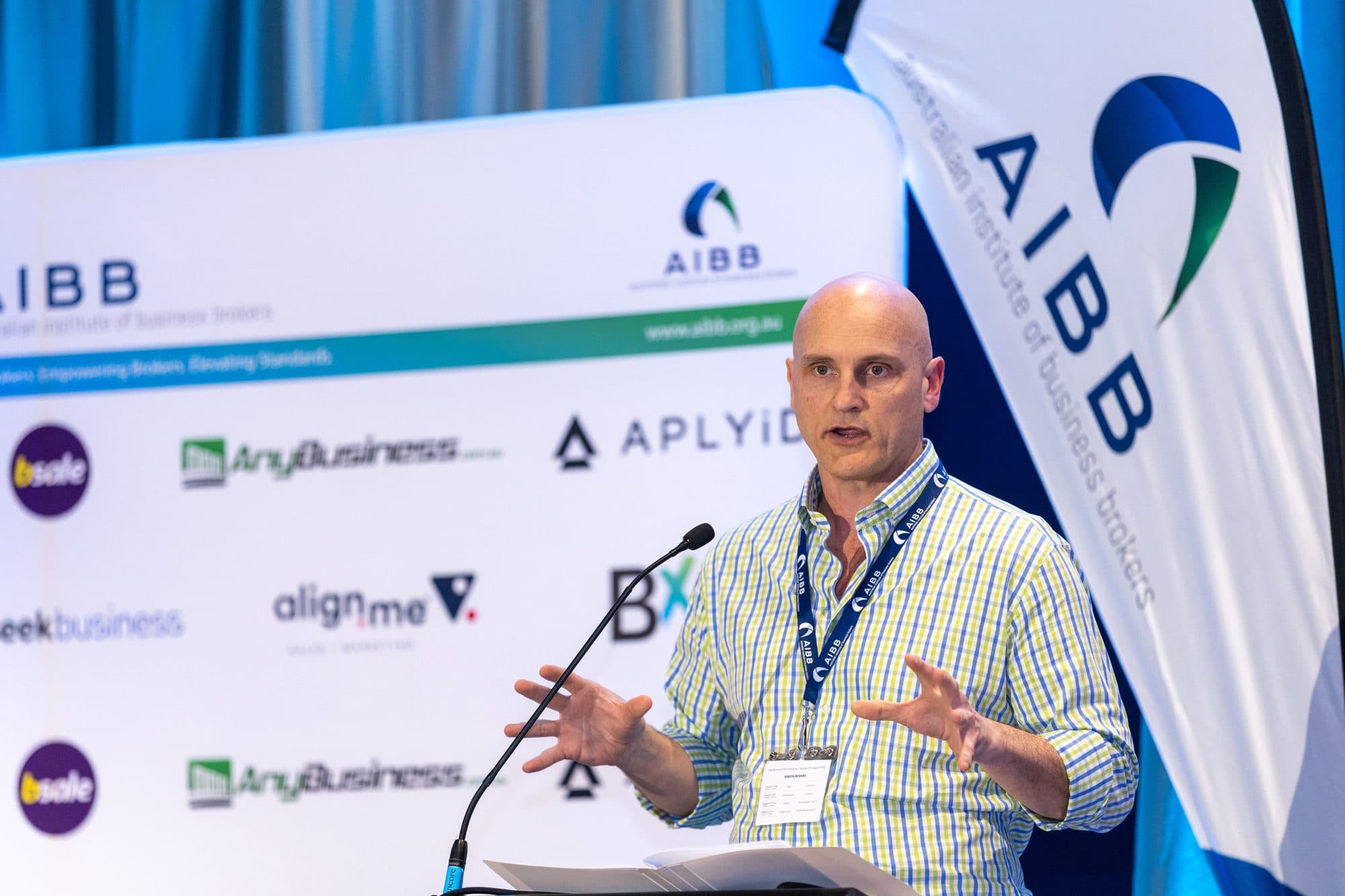 Simon Bedard speaking at the lectern at the AIBB National Conference in Cairns